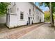 Charming home featuring a blue door, brick walkway, and well-maintained landscaping at 184 Ashley Ave, Charleston, SC 29403