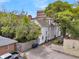 Exterior view of a classic white home, complemented by a fenced yard and ample parking space at 184 Ashley Ave, Charleston, SC 29403