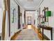 Elegant hallway with hardwood floors, intricate millwork, stylish decor, and a grand entrance door at 184 Ashley Ave, Charleston, SC 29403