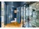 Hallway with decorative glass cabinet and opened door to show a powder room at 184 Ashley Ave, Charleston, SC 29403