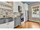 A modern kitchen with stainless steel appliances, custom backsplash, and white cabinets at 184 Ashley Ave, Charleston, SC 29403
