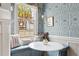 Stylish breakfast nook area with decorative wallpaper and window seats at 184 Ashley Ave, Charleston, SC 29403