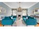Beautiful living room with blue sofas, a fireplace, elegant wallpaper, and lots of natural light at 184 Ashley Ave, Charleston, SC 29403