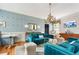 Living room showcasing blue sofas, decorative wallpaper, and a classic chandelier, creating a welcoming space at 184 Ashley Ave, Charleston, SC 29403