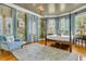 A relaxing main bedroom features wallpaper, canopy bed, hardwood floors, and a plush chair at 184 Ashley Ave, Charleston, SC 29403