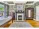 A sophisticated main bedroom with fireplace, wooden floors, wardrobe, and detailed wallpaper at 184 Ashley Ave, Charleston, SC 29403