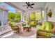 Inviting covered porch with ample seating and a ceiling fan perfect for relaxing outdoors at 184 Ashley Ave, Charleston, SC 29403
