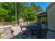 Charming back patio featuring a stone fireplace, comfortable seating, and an outdoor dining area at 204 Black Gum Cir, Moncks Corner, SC 29461