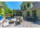 Beautiful back patio with comfortable seating, outdoor dining area, and charming stone details at 204 Black Gum Cir, Moncks Corner, SC 29461