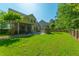 Expansive backyard with a stone patio, outdoor seating, and lush green lawn at 204 Black Gum Cir, Moncks Corner, SC 29461