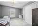 Neutral-toned bedroom with a twin bed, a built-in desk, and ample closet space at 204 Black Gum Cir, Moncks Corner, SC 29461