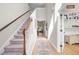 Inviting entryway with staircase, light wood floors, a stylish rug, and bright natural light streaming in at 204 Black Gum Cir, Moncks Corner, SC 29461