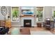 Living room featuring a fireplace with a wooden mantel and ample natural light at 204 Black Gum Cir, Moncks Corner, SC 29461
