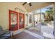 Inviting screened porch with red door and a view of the outdoor patio at 204 Black Gum Cir, Moncks Corner, SC 29461