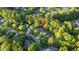 Aerial view of a neighborhood with lush trees and a house identified with a red pin on the roof at 213 Factors Walk, Summerville, SC 29485