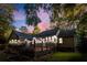 Inviting backyard deck with wooden floors and charming exterior lighting under a beautiful sunset sky at 213 Factors Walk, Summerville, SC 29485