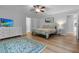 Bright bedroom features a ceiling fan, white dresser with television, and area rug at 213 Factors Walk, Summerville, SC 29485