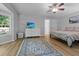 Bright bedroom features a ceiling fan, white dresser with television, and area rug at 213 Factors Walk, Summerville, SC 29485