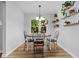 Dining room featuring wood floors, view to outdoors, and plant shelf at 213 Factors Walk, Summerville, SC 29485