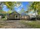 Rear exterior view of home featuring a sunroom, deck and mature trees at 213 Factors Walk, Summerville, SC 29485