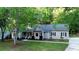Exterior view of the house showing well-manicured landscaping, inviting entrance, and classic architectural details at 213 Factors Walk, Summerville, SC 29485