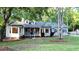 Charming one-story home with a well-manicured lawn and lush landscaping in a serene, tree-filled setting at 213 Factors Walk, Summerville, SC 29485