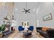 Living room featuring a stone fireplace, hardwood floors, a ceiling fan, and elegant furnishings at 213 Factors Walk, Summerville, SC 29485