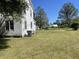 Expansive backyard with lush green lawn, framed by trees and neighboring homes at 217 Scotia St, McClellanville, SC 29458