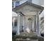 Inviting front porch with columns and the house number '217' adding to its charm at 217 Scotia St, McClellanville, SC 29458