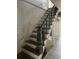 Rustic staircase featuring wood steps, decorative railing and natural light, offering a glimpse into the house's character at 217 Scotia St, McClellanville, SC 29458