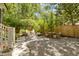 Private fenced backyard features stone ground cover, lounge chairs and a patio table perfect for outdoor gatherings at 2187 Saint James Dr, Charleston, SC 29412