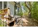 Backyard area with wooded privacy and a hot tub situated next to exterior of the home at 2187 Saint James Dr, Charleston, SC 29412