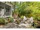Inviting backyard with stone ground cover, a cozy seating area, and mature landscaping at 2187 Saint James Dr, Charleston, SC 29412
