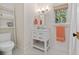 Cozy bathroom with a vanity, a window with a blind, and a decorative ladder shelf at 2187 Saint James Dr, Charleston, SC 29412