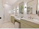Bright bathroom features double vanity with marble countertops, tiled shower, and natural lighting at 2187 Saint James Dr, Charleston, SC 29412