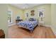 Well-lit bedroom with bright green walls, wood flooring, and large windows at 2187 Saint James Dr, Charleston, SC 29412