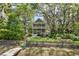 Inviting two-story home with double porches, lush landscaping, and mature trees with Spanish moss at 2187 Saint James Dr, Charleston, SC 29412