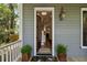Inviting front porch featuring an open door to reveal interior details and stylish exterior decor at 2187 Saint James Dr, Charleston, SC 29412