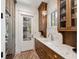 Stylish mudroom boasts granite countertops, custom cabinetry, brick floors, and stainless steel appliances at 2187 Saint James Dr, Charleston, SC 29412