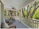 Relaxing porch with comfortable seating, ceiling fan, and serene views of surrounding trees at 2187 Saint James Dr, Charleston, SC 29412