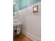 Charming powder room features hardwood floors, unique wallpaper, and pedestal sink with a decorative mirror at 2187 Saint James Dr, Charleston, SC 29412