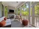 Cozy screened porch with a fireplace, comfortable seating, and views of the lush outdoors at 2187 Saint James Dr, Charleston, SC 29412