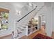 Bright foyer with a staircase, showcasing a built-in bookshelf and wood flooring at 2187 Saint James Dr, Charleston, SC 29412