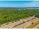 An aerial view showcases land with a bordered property line, surrounded by beautiful trees and greenery at 2234 River Rd, Johns Island, SC 29455
