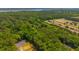 Expansive aerial view of a beautiful wooded lot outlined in yellow, surrounded by lush greenery at 2234 River Rd, Johns Island, SC 29455
