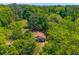 Charming aerial view of a quaint home nestled among mature trees, offering a private and serene setting at 2234 River Rd, Johns Island, SC 29455