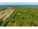Aerial view of an expansive 5.03 acre property outlined in yellow, featuring lush trees and a grassy field at 2234 River Rd, Johns Island, SC 29455