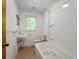 Bright bathroom with a white vanity, toilet, and jacuzzi tub with shower at 2234 River Rd, Johns Island, SC 29455