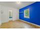 Bright bedroom with a large window, open closet, hardwood floors, and unique blue accent wall at 2234 River Rd, Johns Island, SC 29455