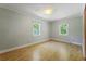 Bedroom with wood floors and two windows providing natural light at 2234 River Rd, Johns Island, SC 29455